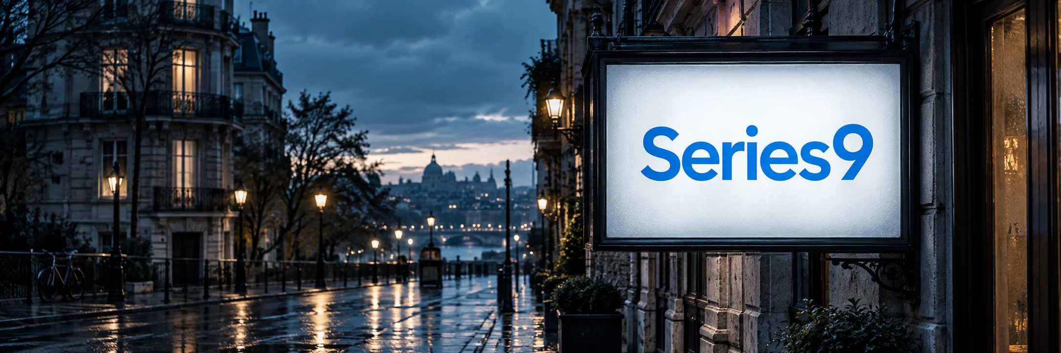 Series9 in blue on a glowing cinema sign beside a rain-washed street